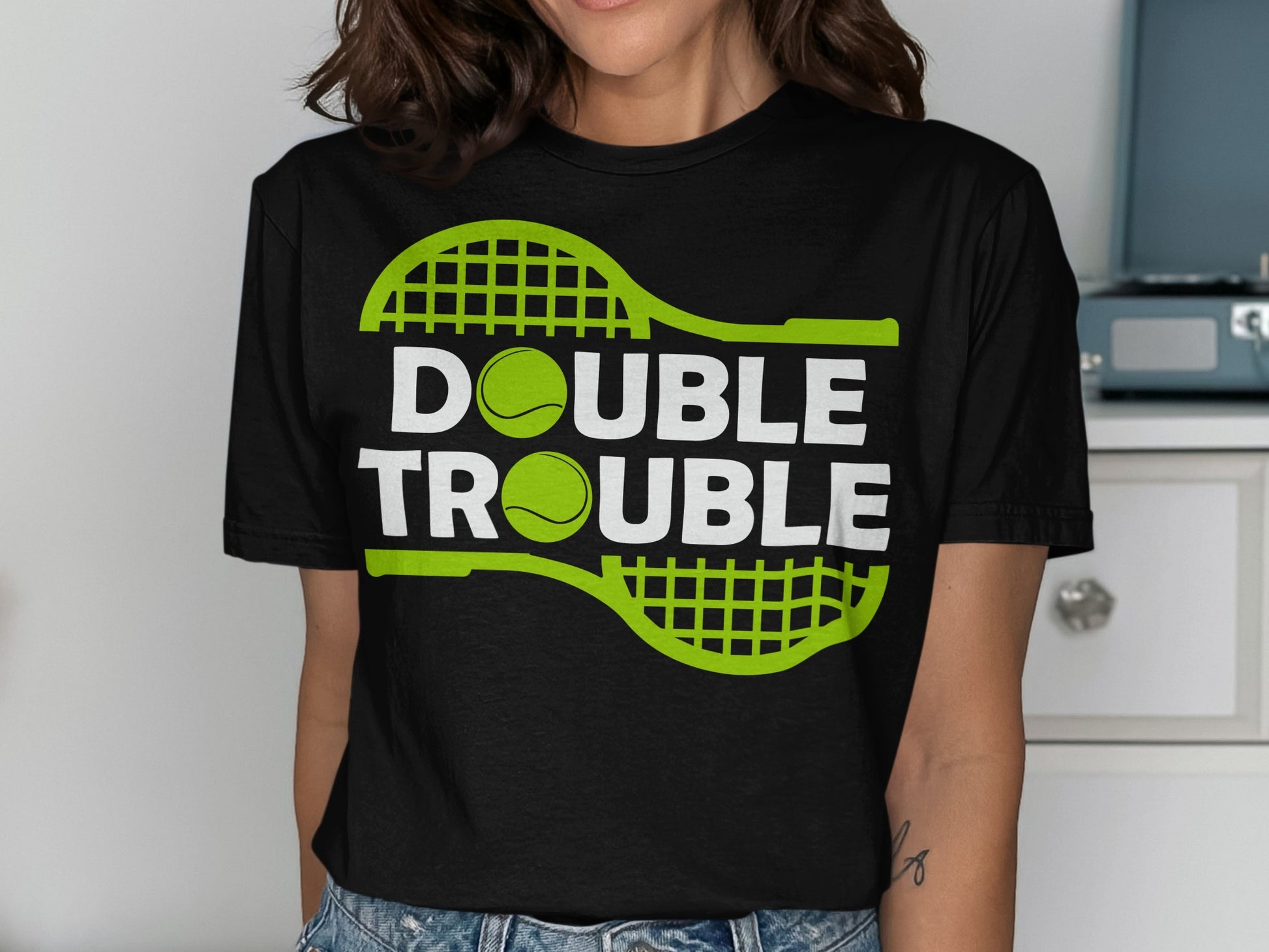 Black t-shirt with "DOUBLE TROUBLE" text and tennis rackets and balls.