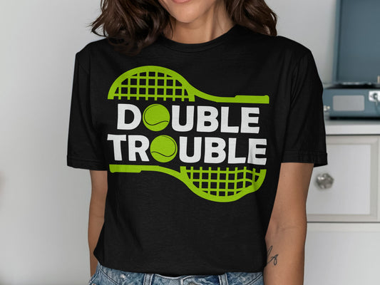 Black t-shirt with "DOUBLE TROUBLE" text and tennis rackets and balls.