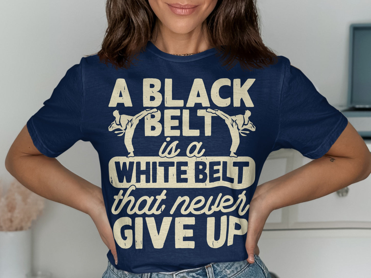 Dark blue t-shirt with "A Black Belt is a White Belt that Never Give Up" text and karate figures.