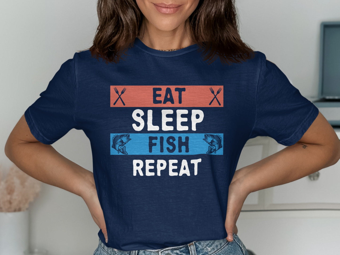 Navy t-shirt with "Eat Sleep Fish Repeat" text and fish graphics.