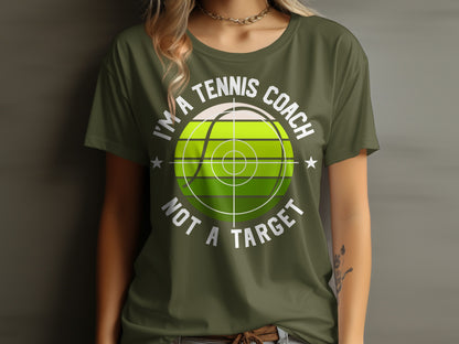 Green t-shirt with "I'm a tennis coach not a target" text and tennis ball graphic.