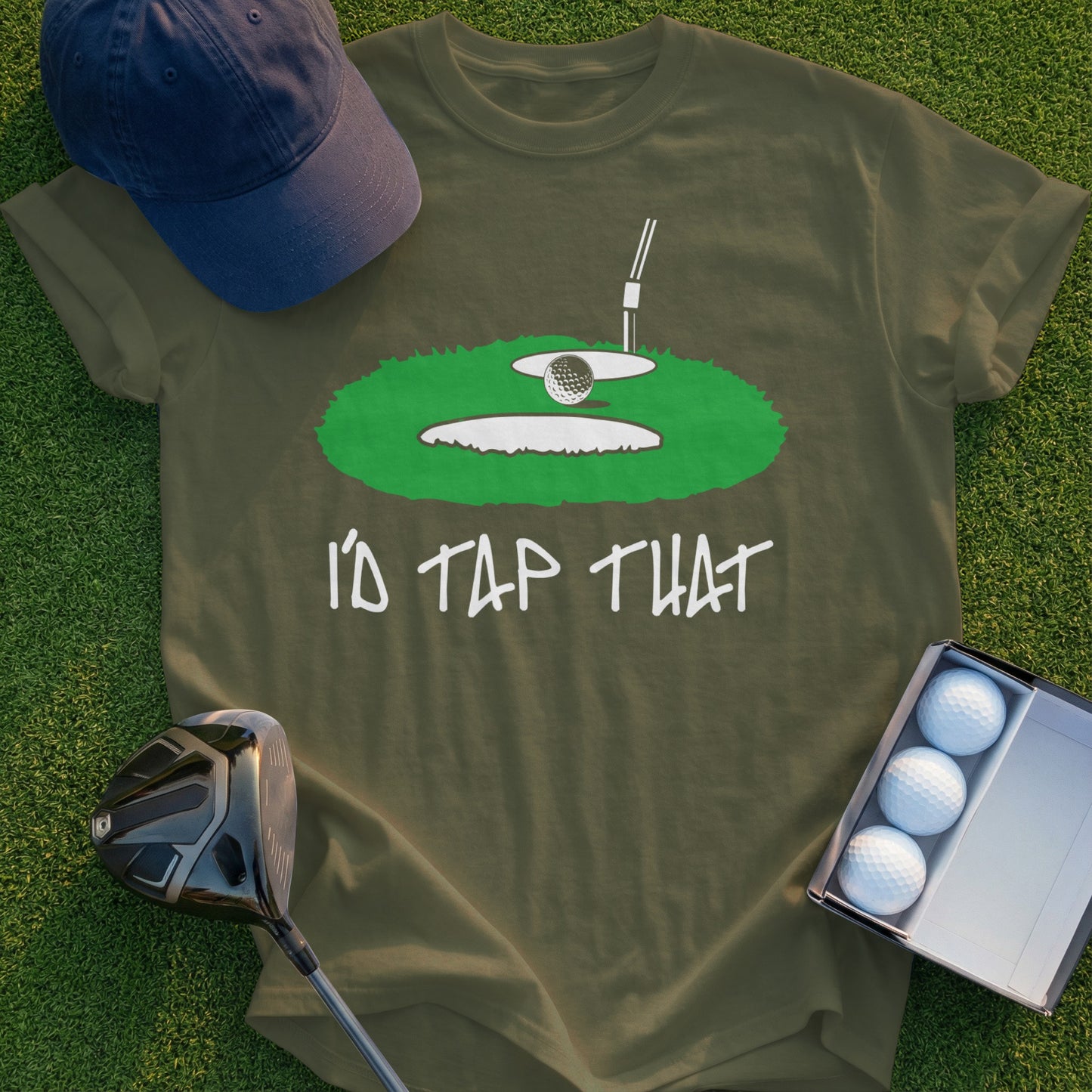 T-shirt with graphic of golf ball in a hole, text "I'd Tap That".
