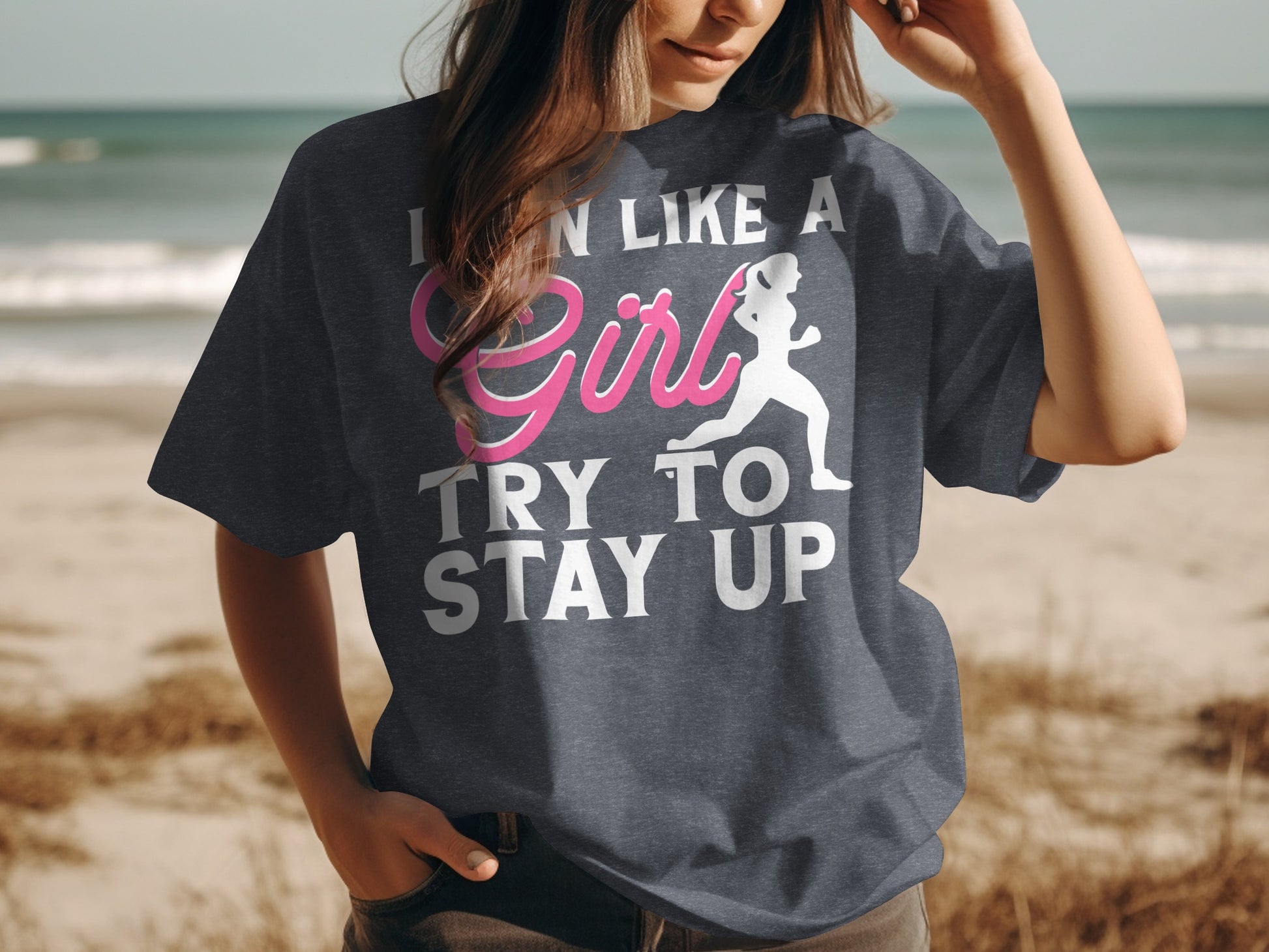 T-shirt with pink text and runner graphic saying "I CAN LIKE A GIRL TRY TO STAY UP".