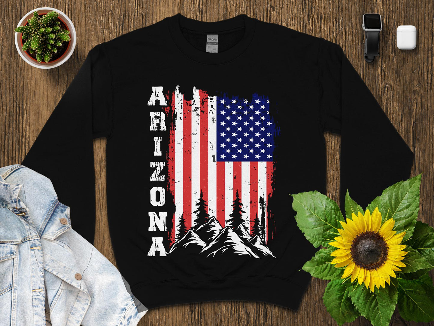 Black sweatshirt with Arizona text and distressed US flag over mountains.