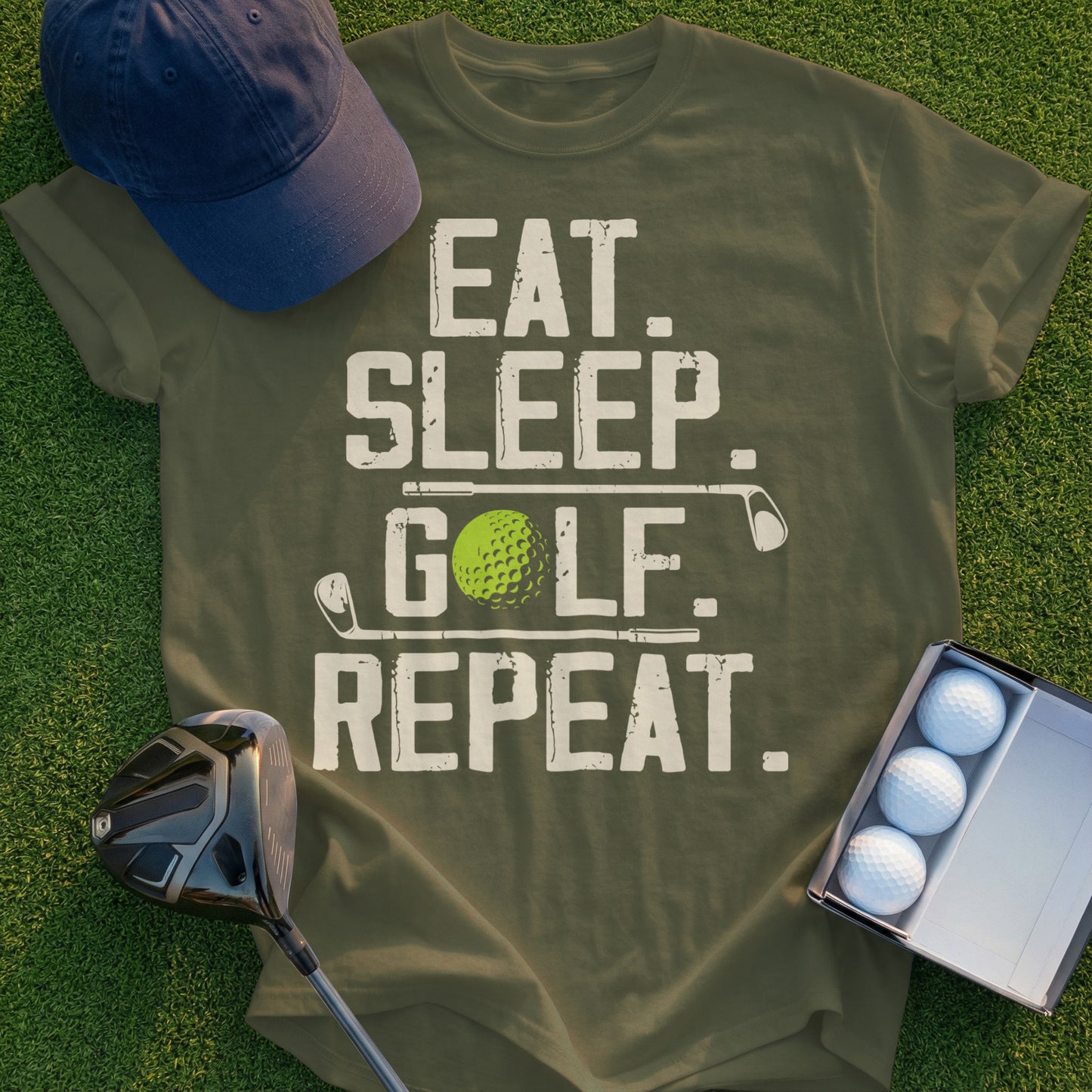 Olive green t-shirt with "EAT. SLEEP. GOLF. REPEAT." text and golf accessories.