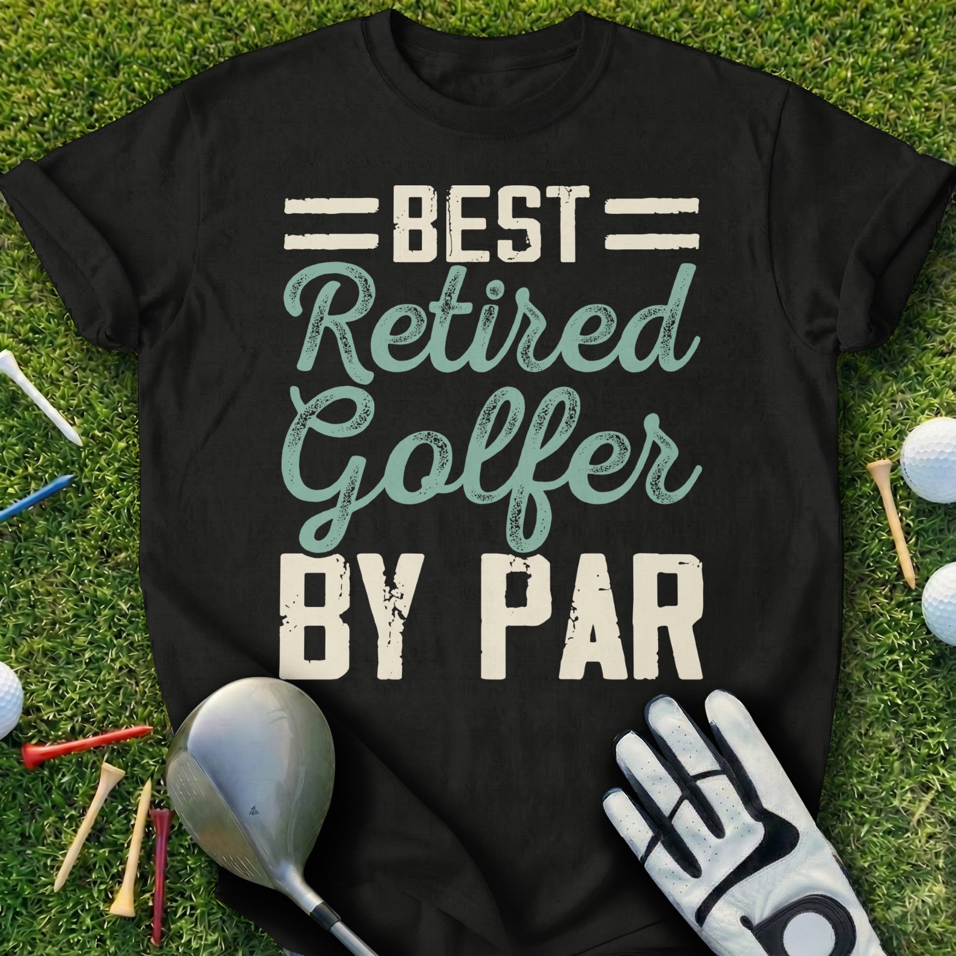 Black t-shirt with "Best Retired Golfer By Par" graphic on grass.
