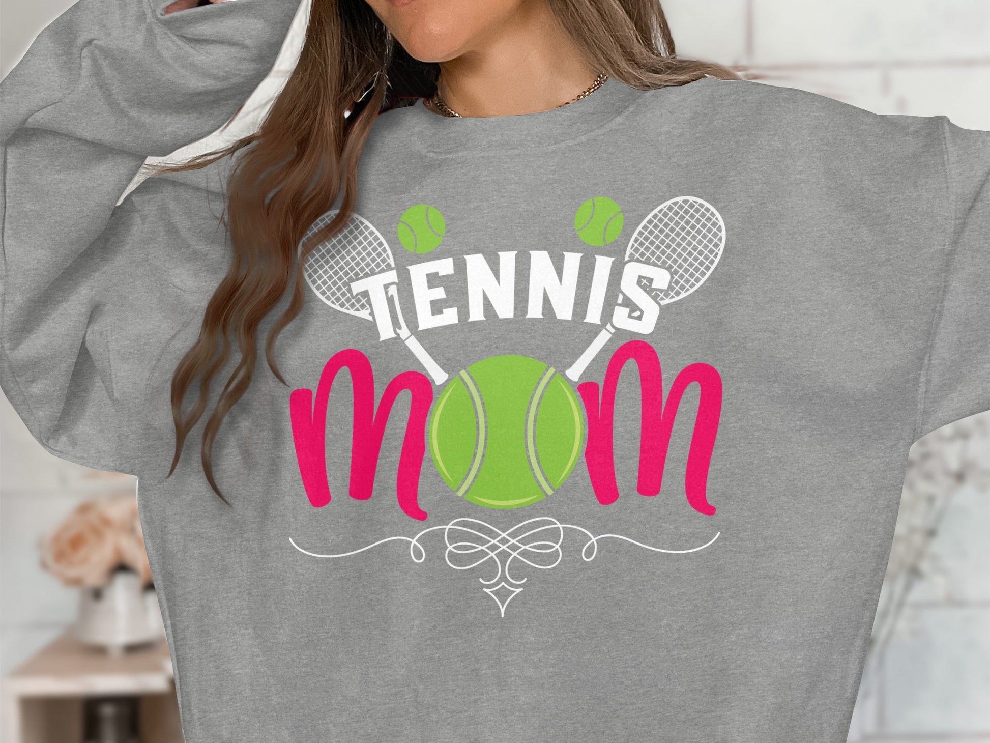 Gray sweatshirt with "Tennis Mom" text, tennis balls, and rackets graphic.