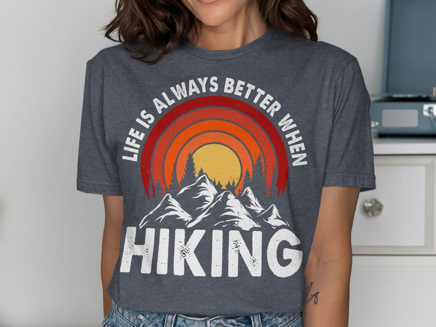 T-shirt with mountains, sun, and text "Life is always better when HIKING".