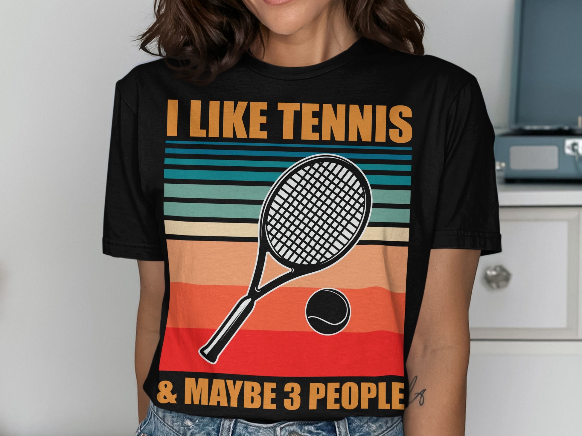 Black t-shirt with "I LIKE TENNIS & MAYBE 3 PEOPLE" and tennis racket graphic.