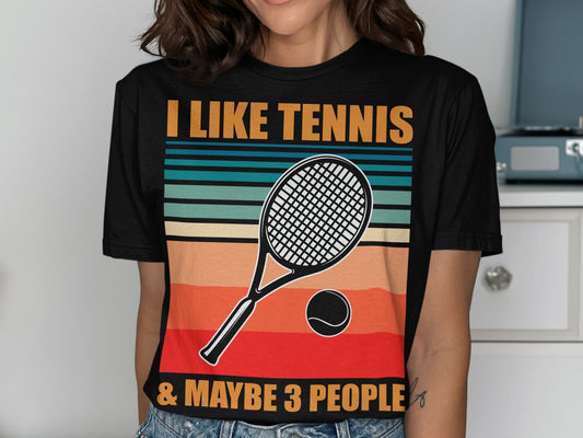 Black t-shirt with "I LIKE TENNIS & MAYBE 3 PEOPLE" and tennis racket graphic.