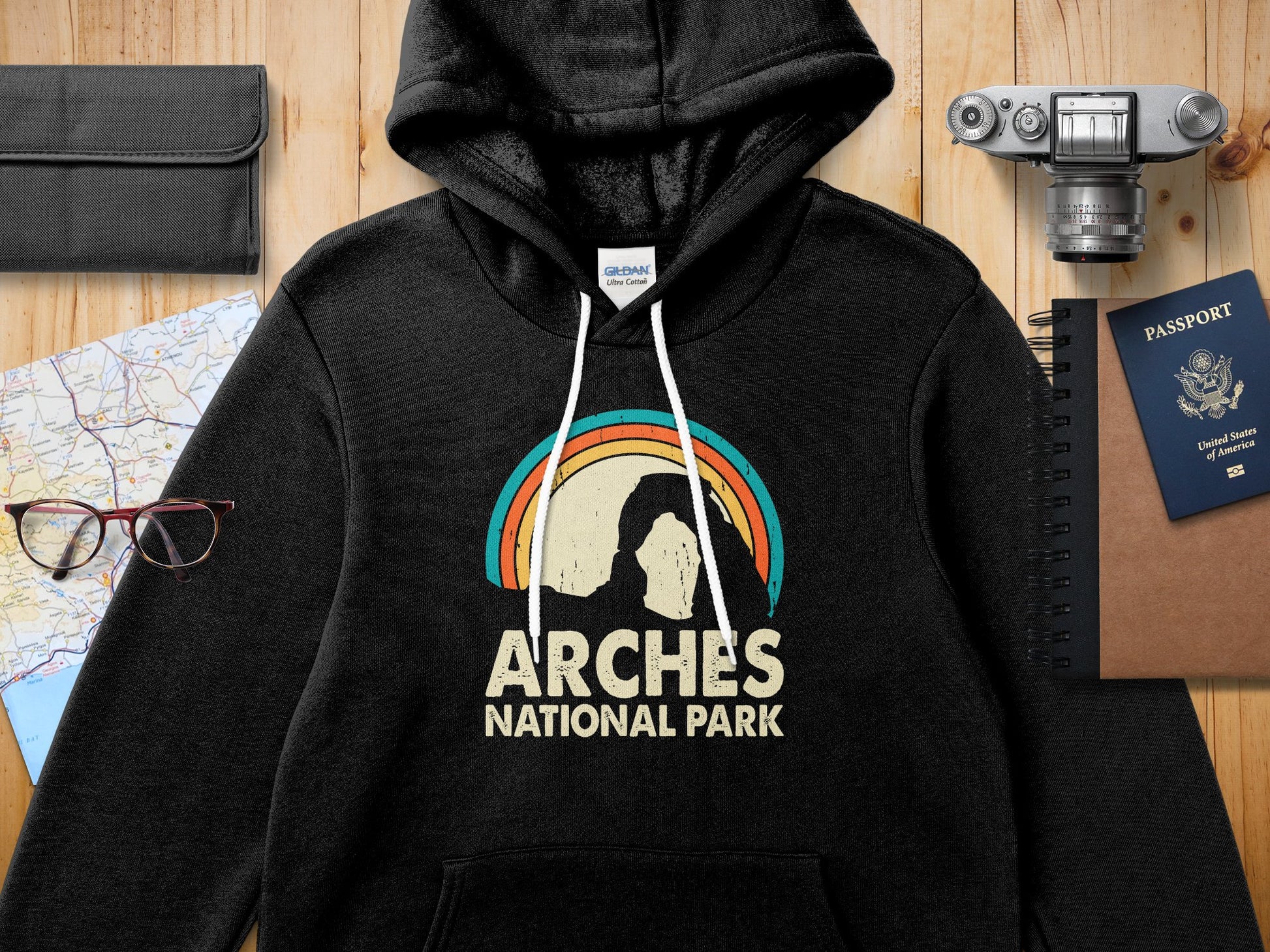 Black Gildan hoodie with Arches National Park rainbow arch logo.