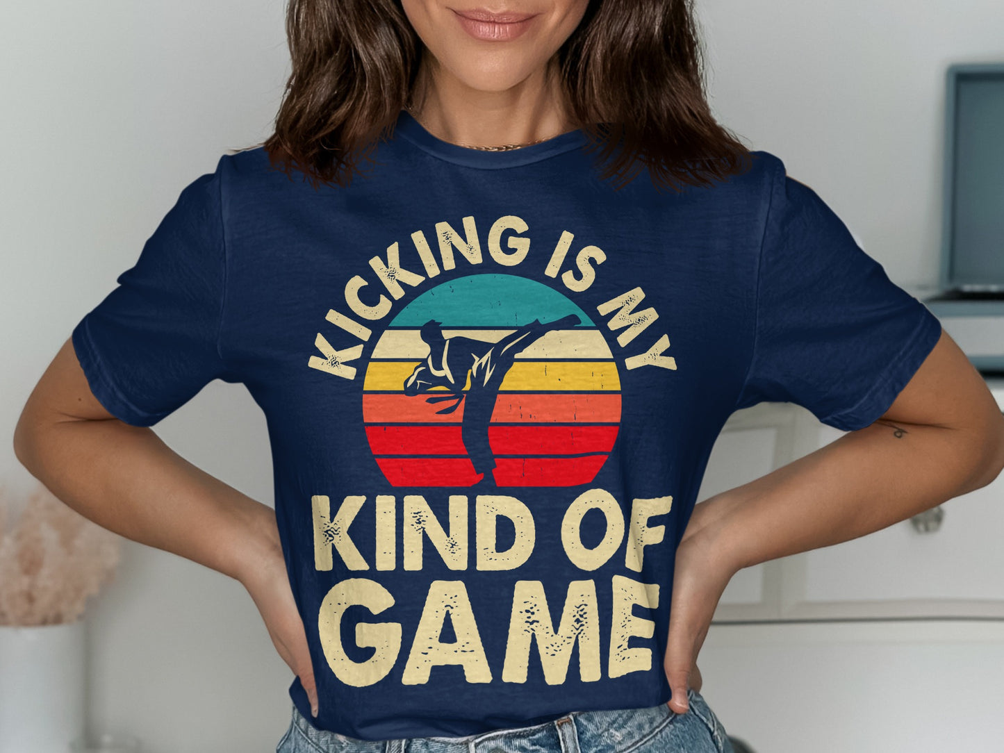 Navy t-shirt with retro sunset graphic and "Kicking is my kind of game" text.