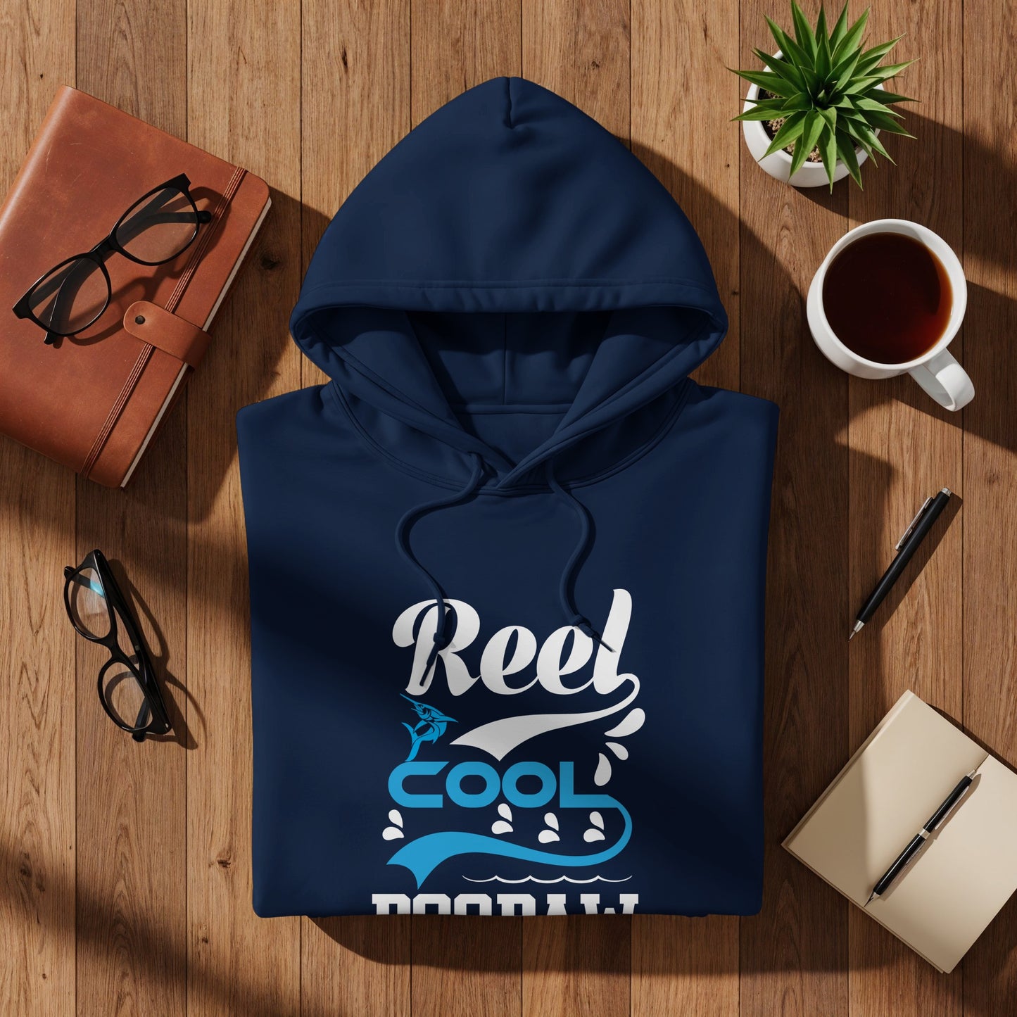 Navy blue hoodie with "Reel Cool" text and wave graphics.