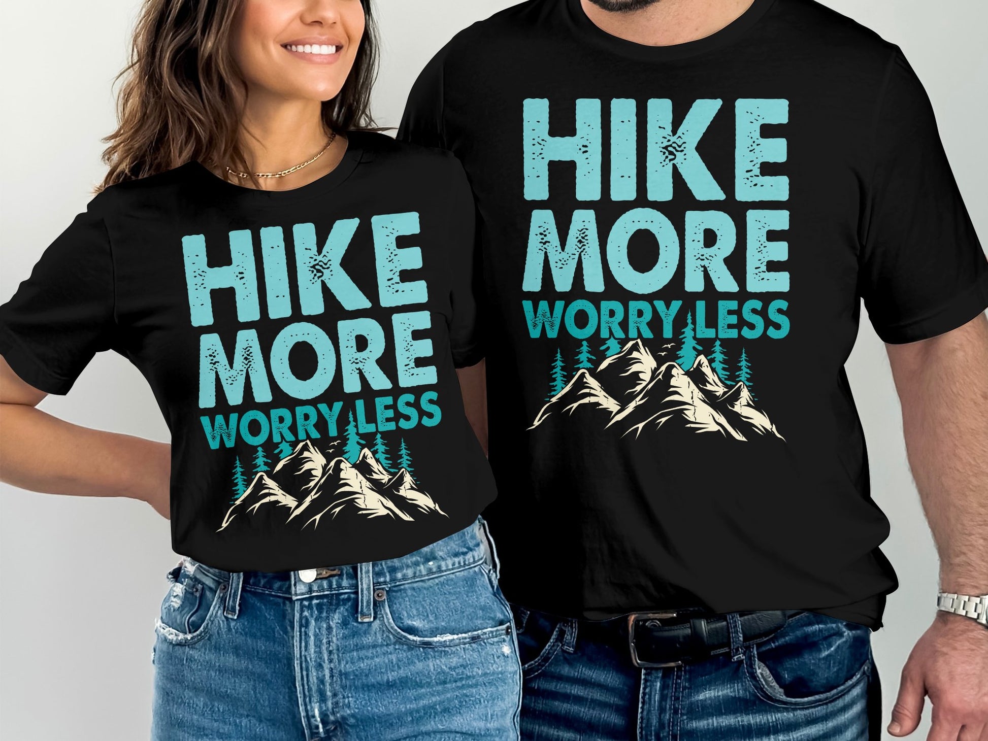 Couple wearing matching "Hike More Worry Less" t-shirts with mountain graphic.