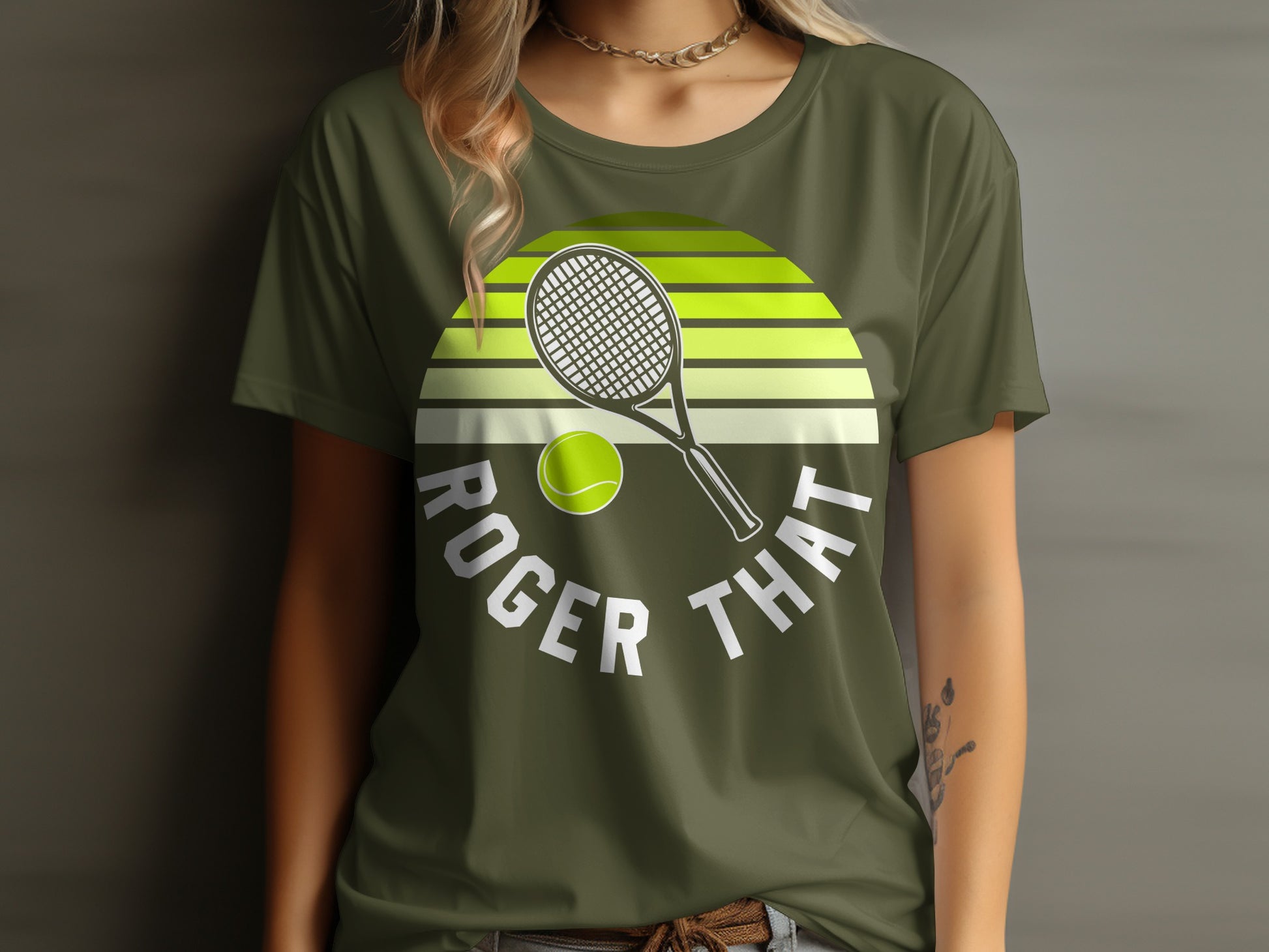 Green t-shirt with Roger That text, tennis racket, and ball.