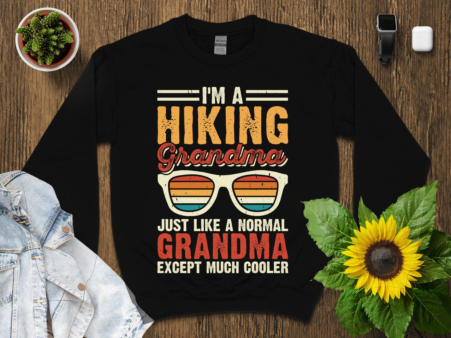 Black sweatshirt with "I'm a Hiking Grandma Just Like a Normal Grandma Except Much Cooler" text.
