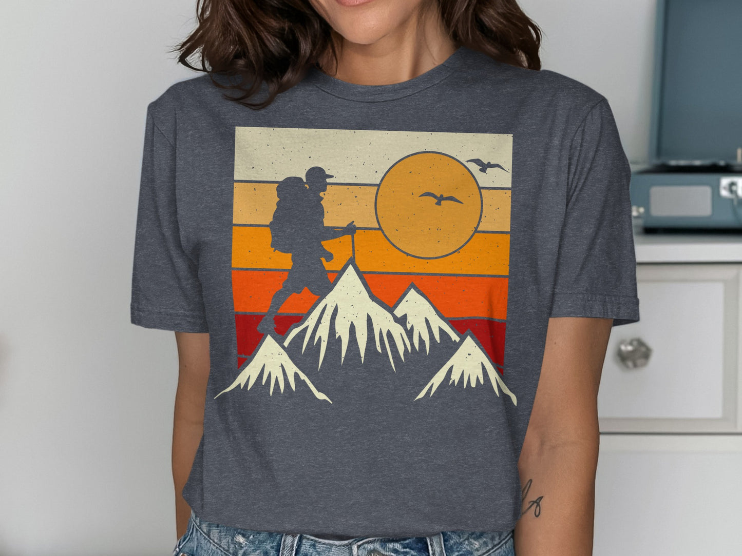 Vintage graphic t-shirt with a hiker, mountains, and sunset graphic.