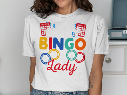 Woman wearing a white t-shirt with colorful "BINGO Lady" text and bingo cards.