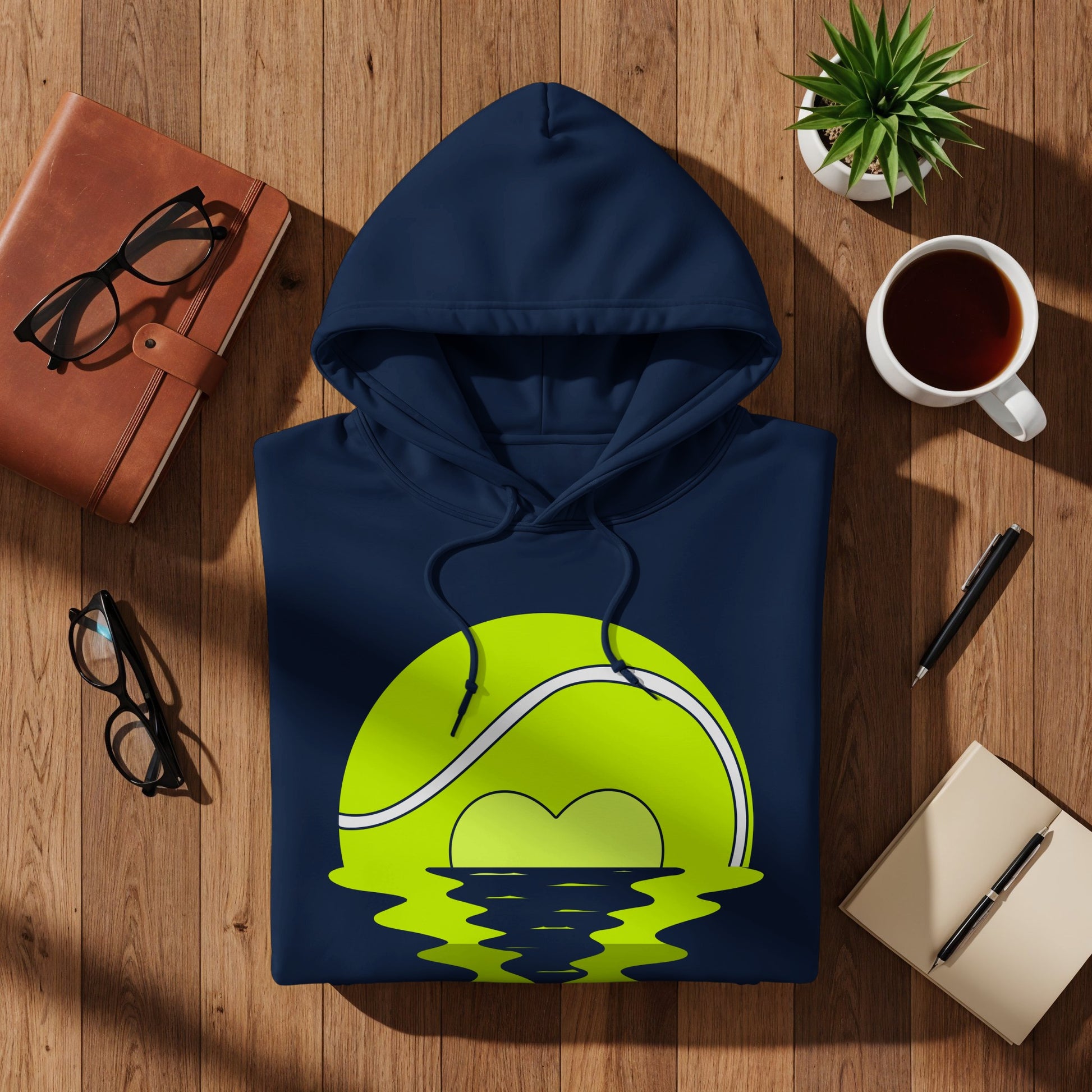 Navy blue hoodie with a green tennis ball rising over water design.