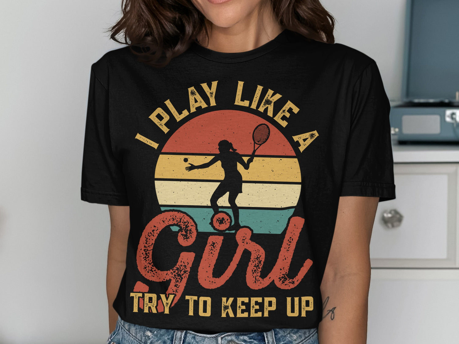 Black t-shirt with "I PLAY LIKE A GIRL TRY TO KEEP UP" and tennis silhouette.