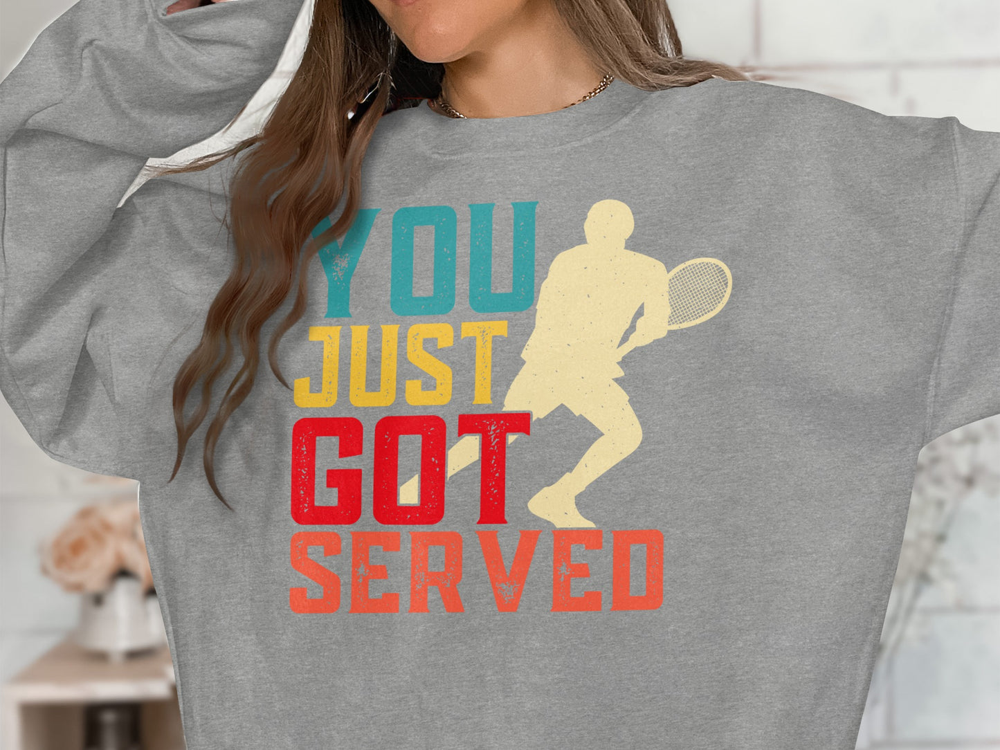 Gray sweatshirt with "YOU JUST GOT SERVED" text and tennis player graphic.