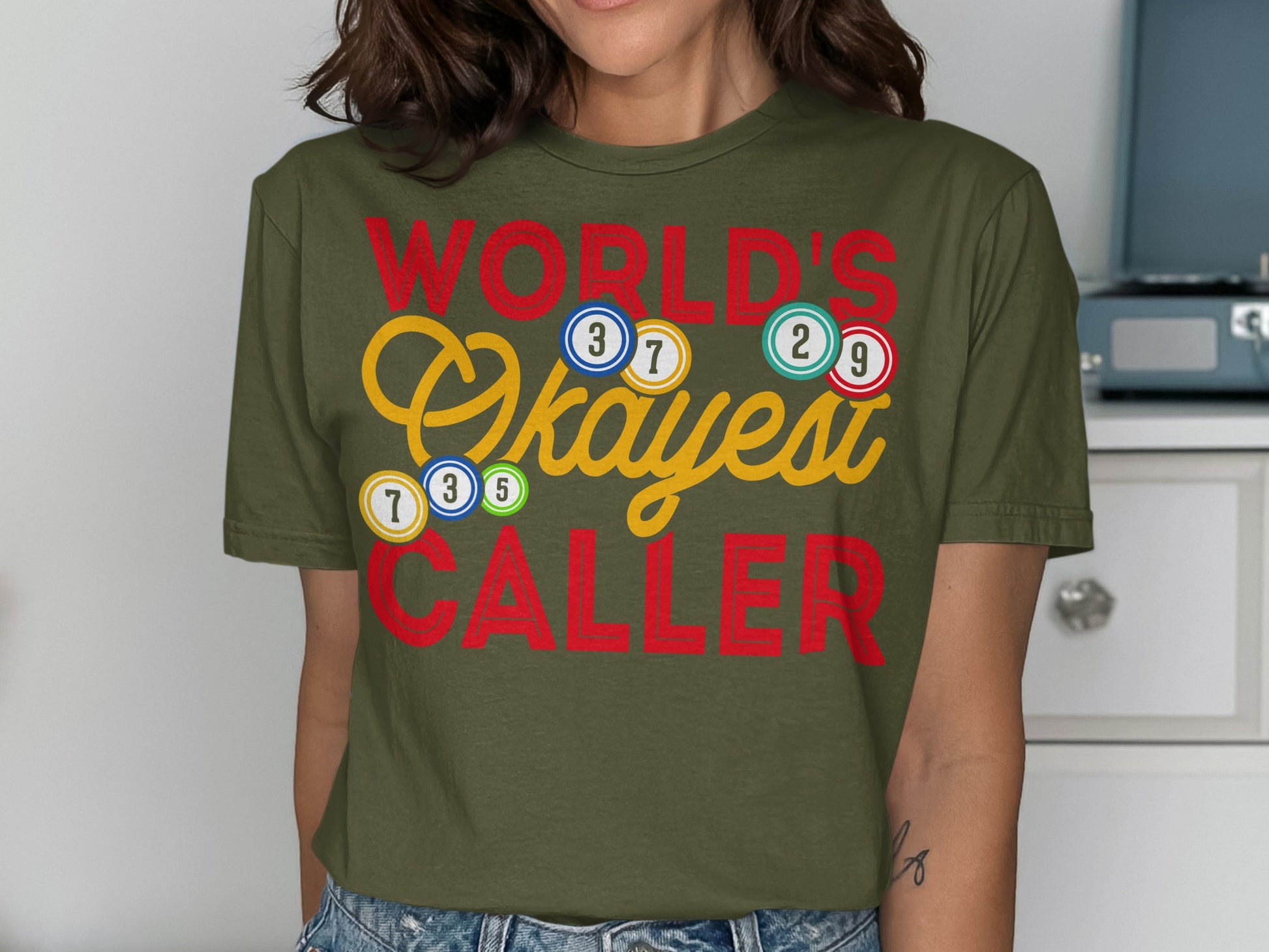 T-shirt with "World's Okayest Caller" text and bingo balls.