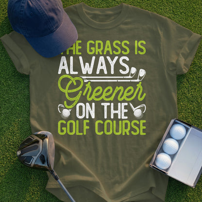 Green t-shirt with "The grass is always greener on the golf course" text and golf imagery.