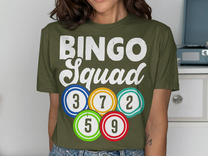 Olive green t-shirt with "BINGO Squad" and colorful bingo balls with numbers.
