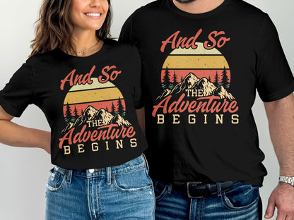 Couple wearing black t-shirts with "And So The Adventure Begins" sunset graphic.