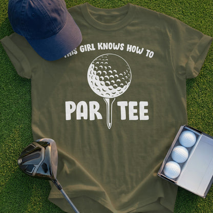 Green t-shirt with "THIS GIRL KNOWS HOW TO PAR-TEE" text and golf ball graphic.