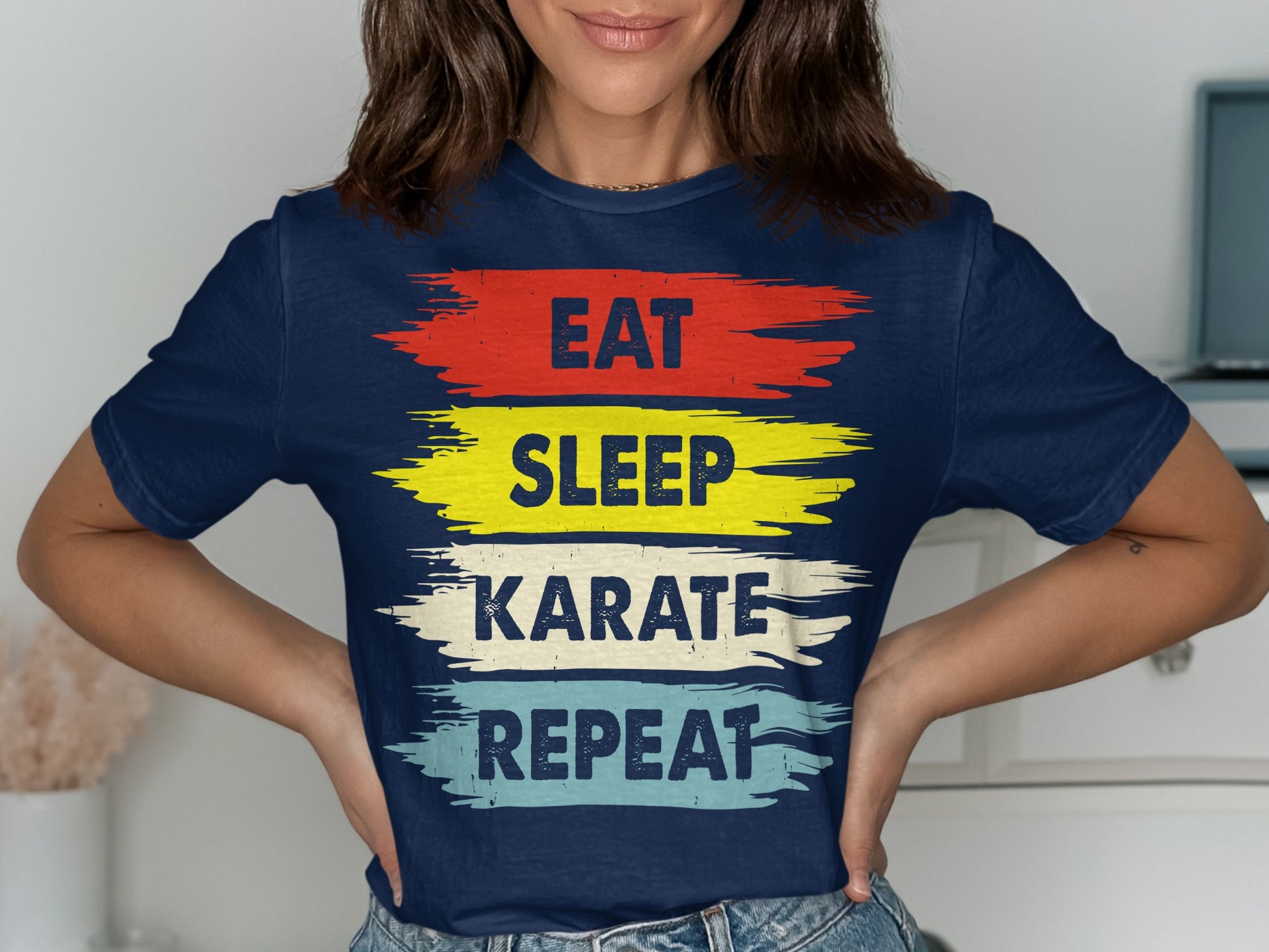 Navy t-shirt with "Eat Sleep Karate Repeat" in colorful brushstroke text.