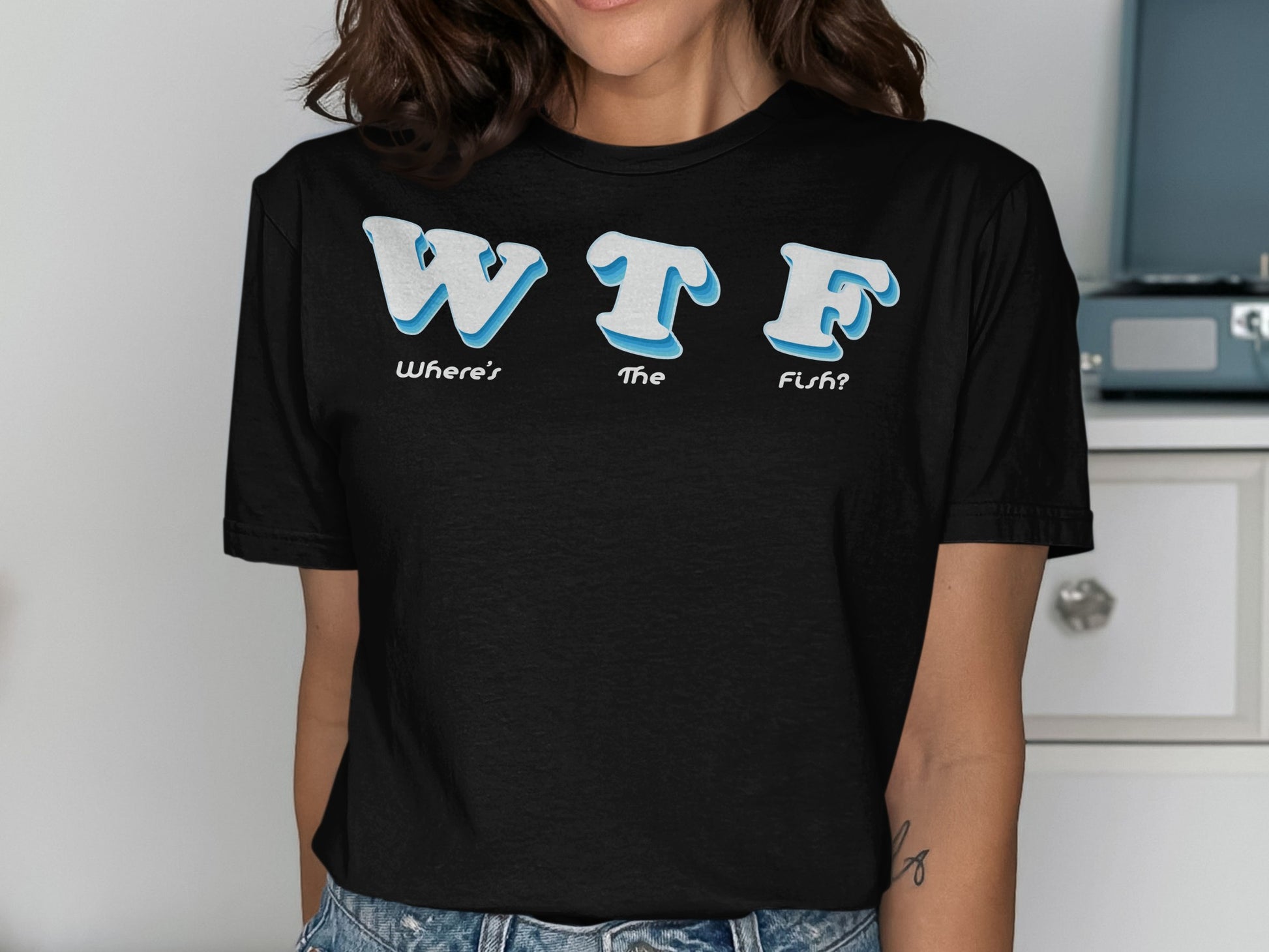 Black t-shirt with "WTF Where's The Fish?" in blue and white text.
