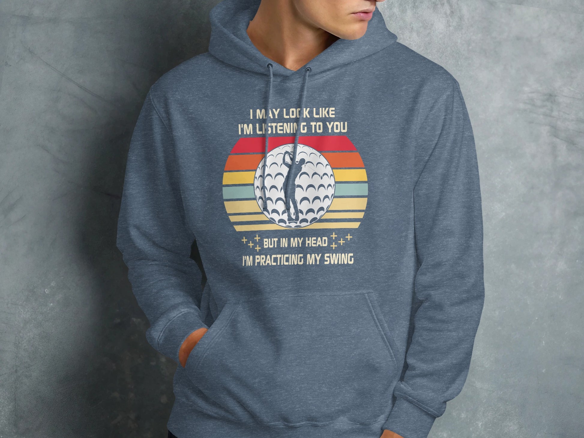 Hoodie with vintage golf ball and sunset graphic and "Practicing My Swing" text.