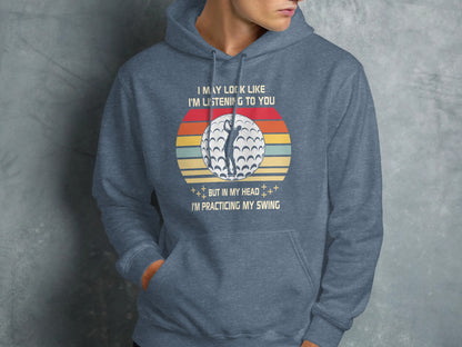Hoodie with vintage golf ball and sunset graphic and "Practicing My Swing" text.