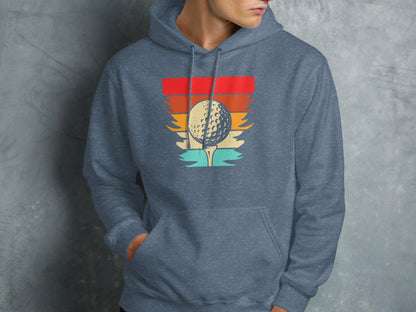 Golf ball on tee with vintage sunset graphic on gray hoodie.