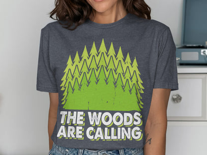 Dark grey t-shirt with green trees and text "THE WOODS ARE CALLING".