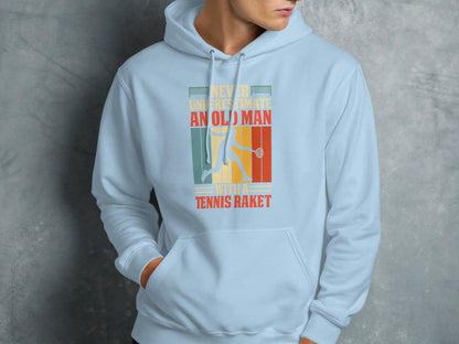 Light blue hoodie with "Never underestimate an old man with a tennis racket" text and tennis player graphic.