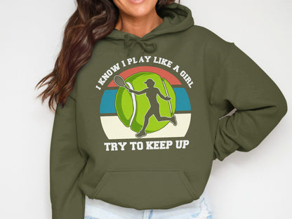 Green hoodie with "I know I play like a girl try to keep up" text and tennis graphic.