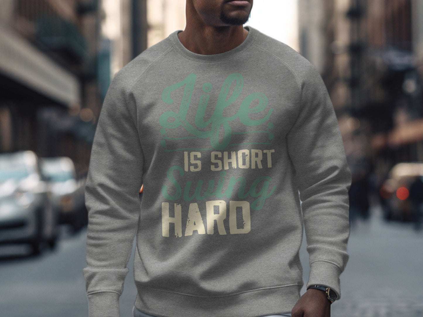Grey sweatshirt with "Life is short swing hard" text across chest.