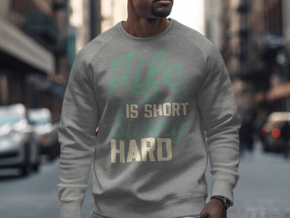Grey sweatshirt with "Life is short swing hard" text across chest.