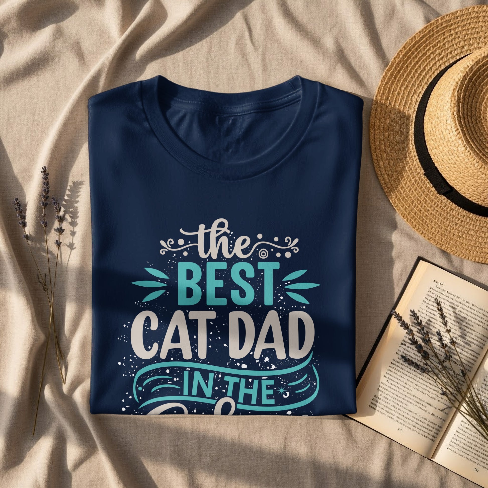 Navy blue t-shirt with "the best cat dad in the world" text and graphic.