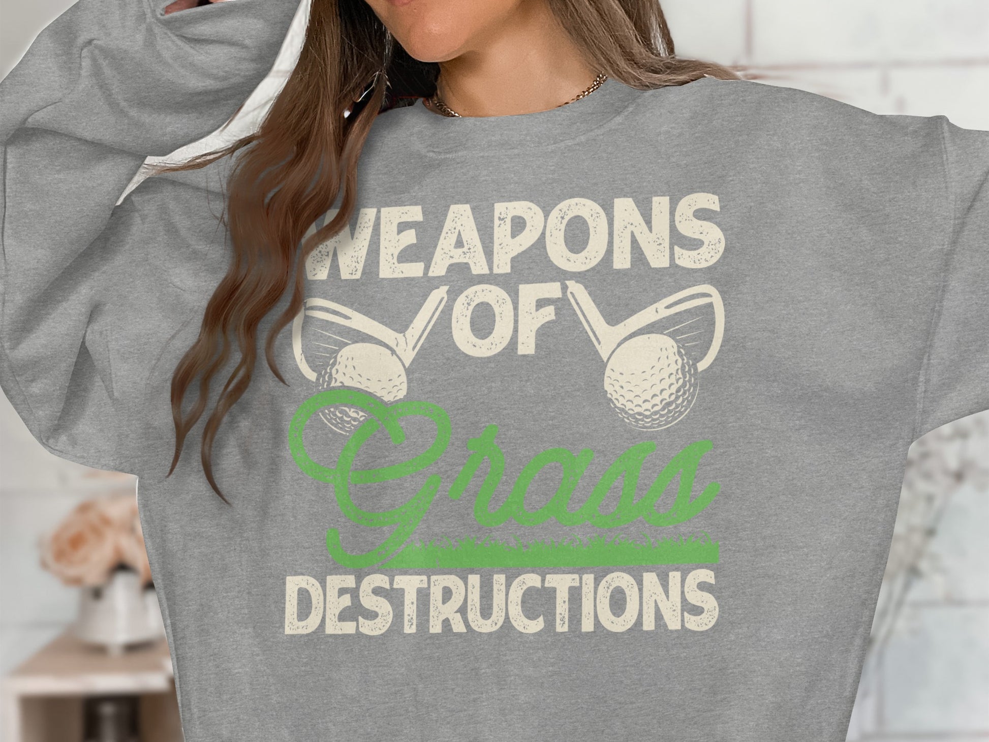 Grey sweatshirt with "Weapons of Grass Destructions" text and golf imagery.