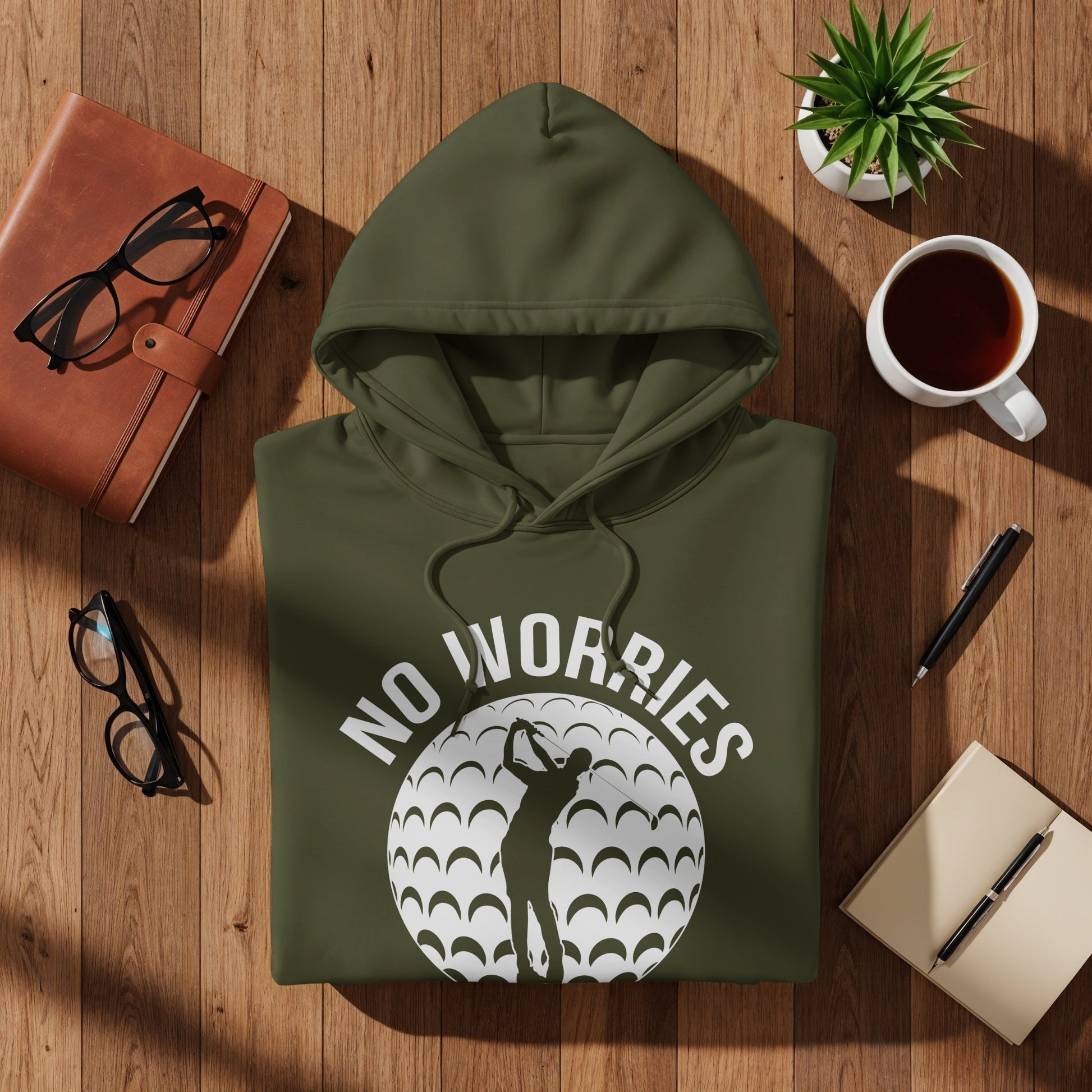 Green hoodie with "NO WORRIES" text and golfer silhouette on textured background.
