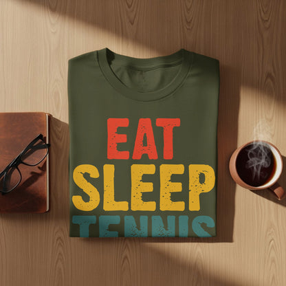 Green t-shirt with "EAT SLEEP TENNIS" in red, yellow, and blue text.