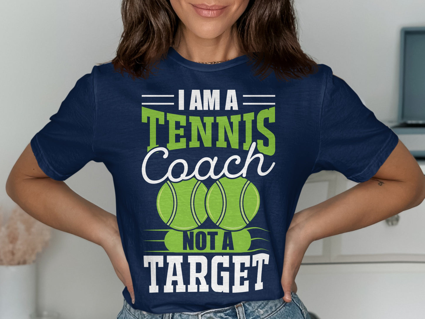 Navy t-shirt with "I Am A Tennis Coach Not A Target" and two tennis balls.