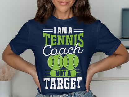 Navy t-shirt with "I Am A Tennis Coach Not A Target" and two tennis balls.