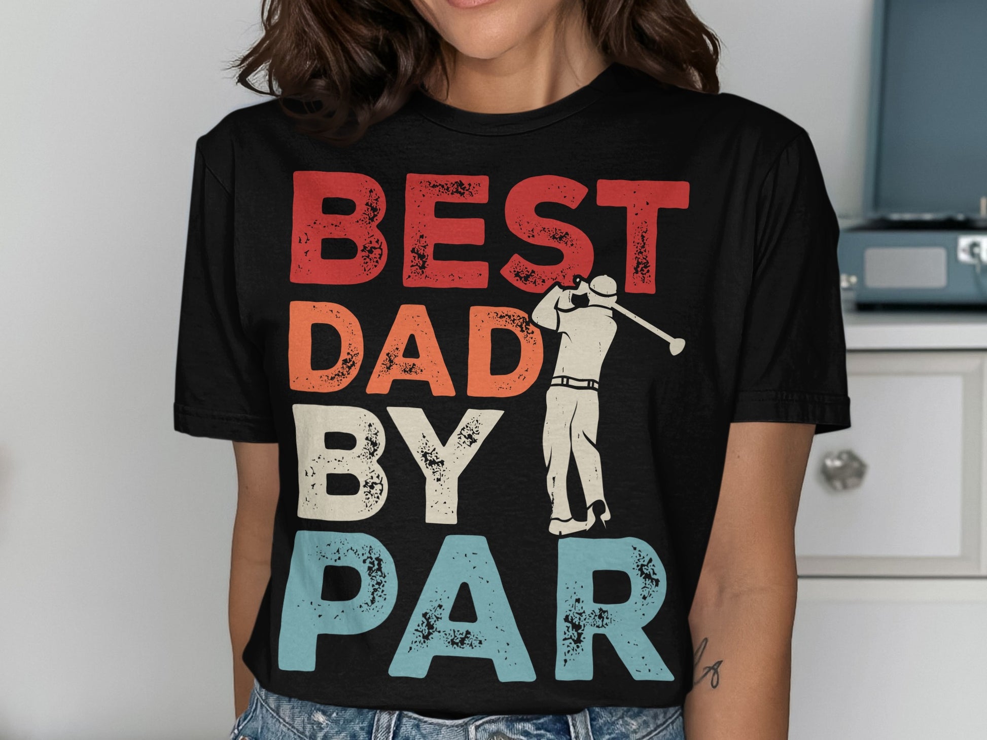 Black t-shirt with "BEST DAD BY PAR" text and golfer graphic.