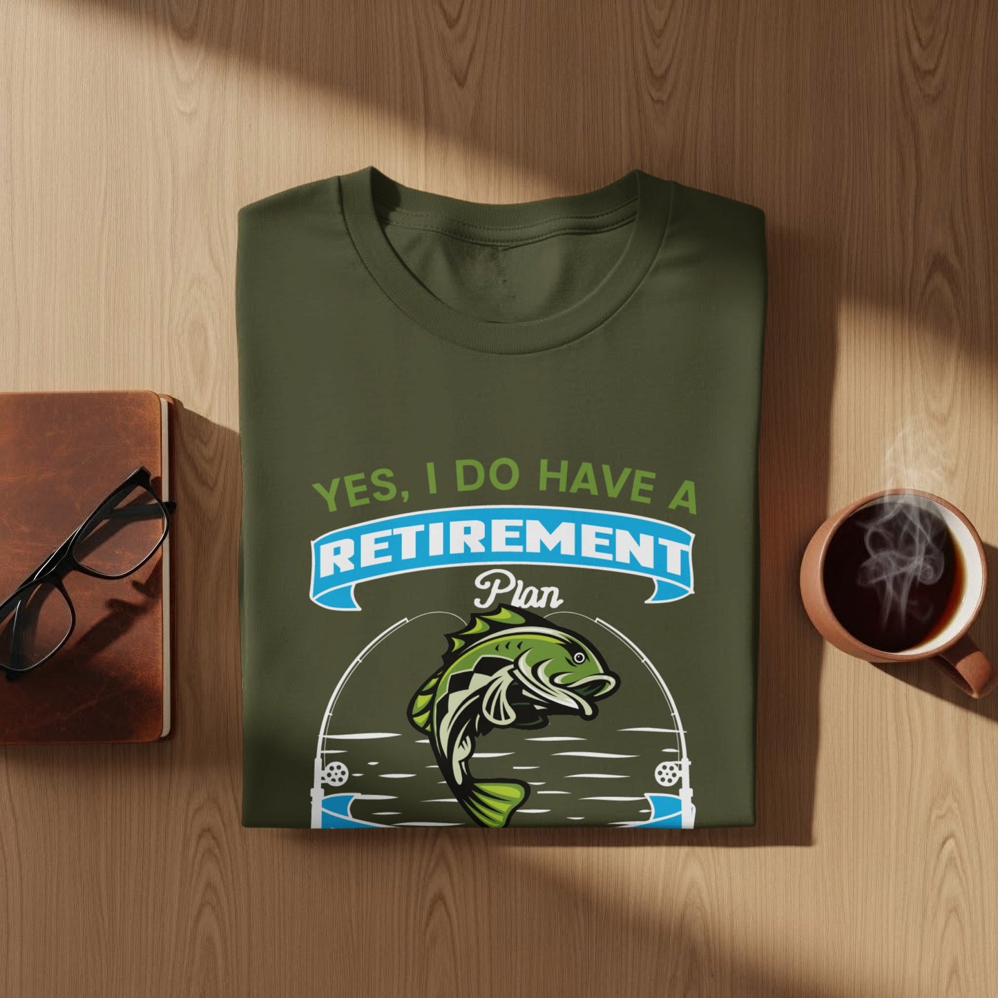Green t-shirt with "Yes, I Do Have A Retirement Plan" text and fish graphic.