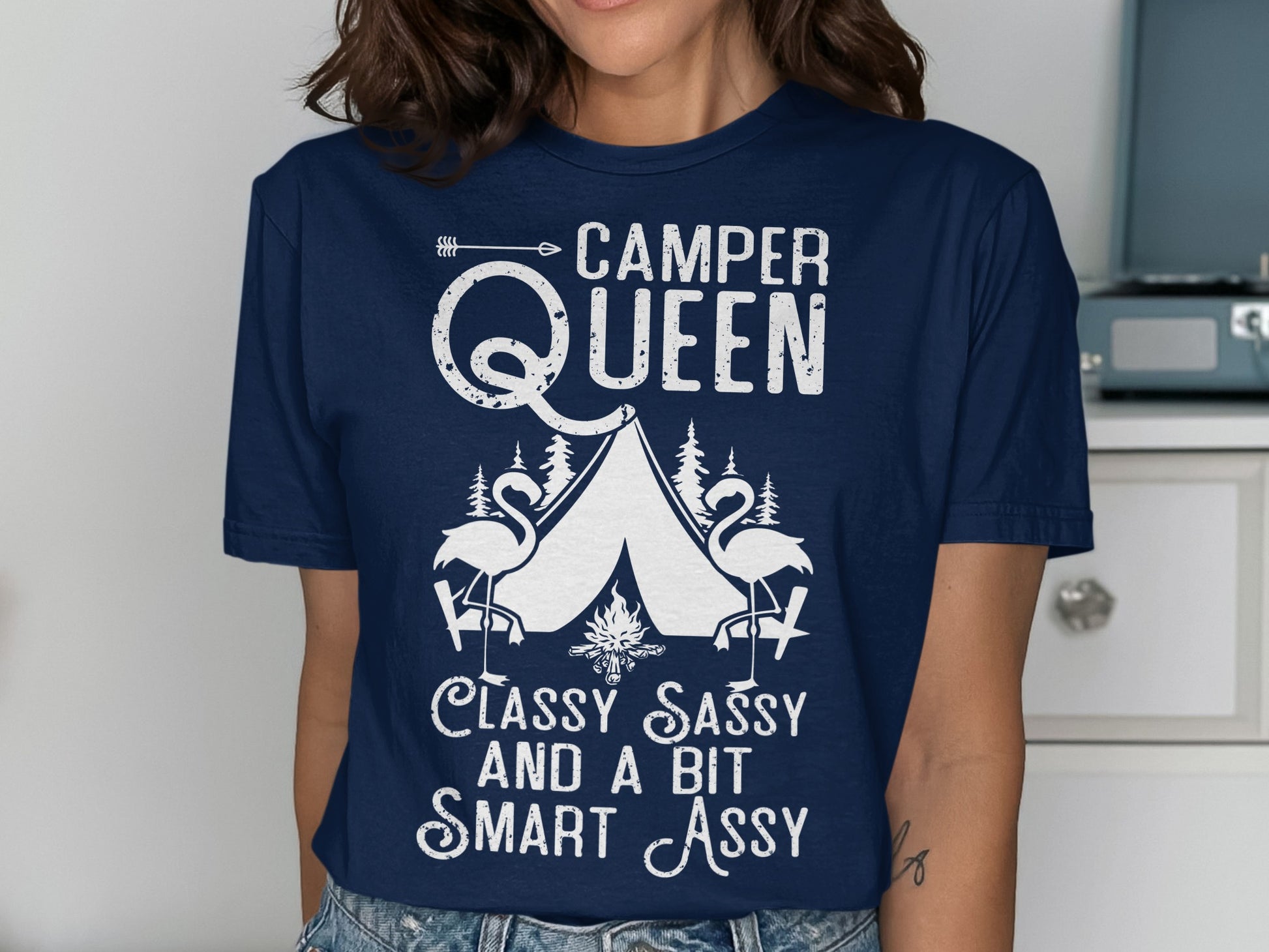 Camper Queen text with flamingos and tents graphic on a navy t-shirt.