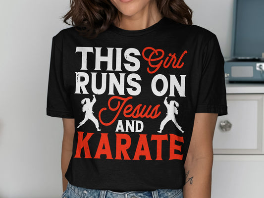 Black t-shirt with white text "THIS Girl RUNS ON Jesus AND KARATE" and karate figures.